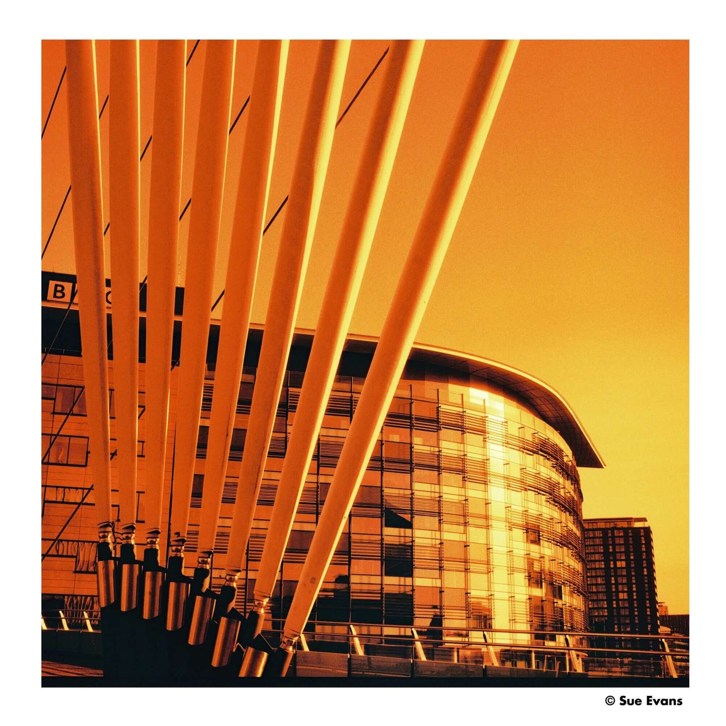 Vibrant orange hues in modern architecture with striking lines and reflections of a contemporary building.