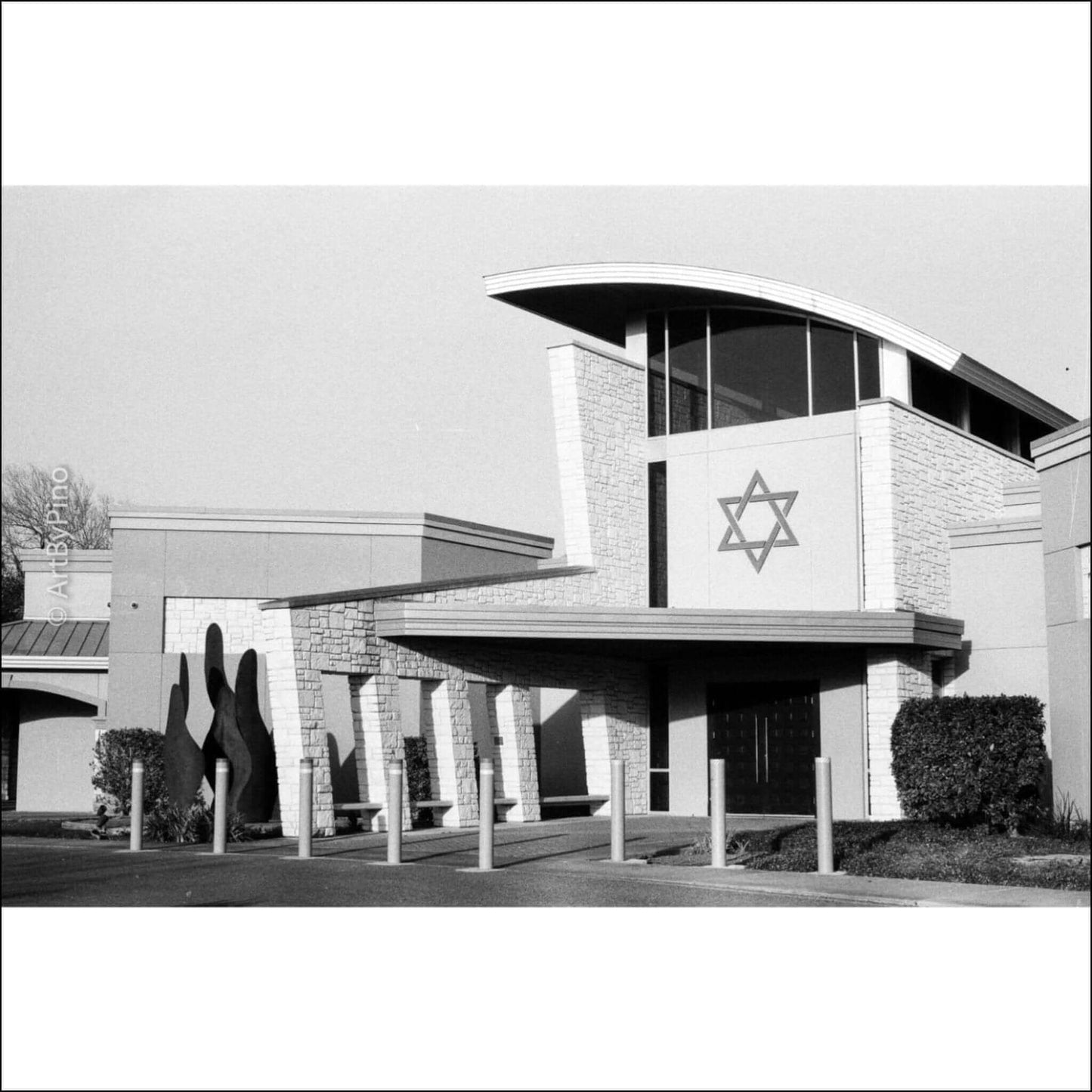Black and white photo of a building with a Star of David design at the entrance.