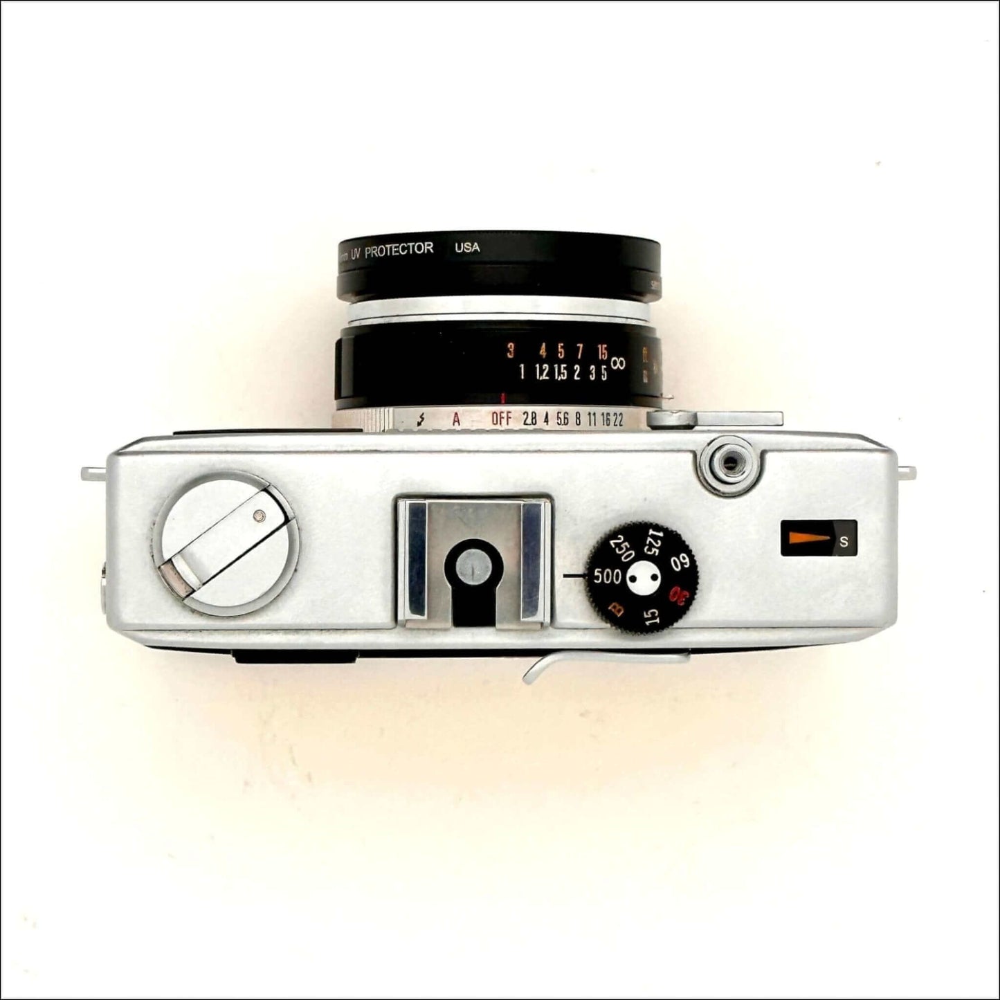 Olympus 35Rc 35mm yellow rangefinder film camera top view with dials and lens.