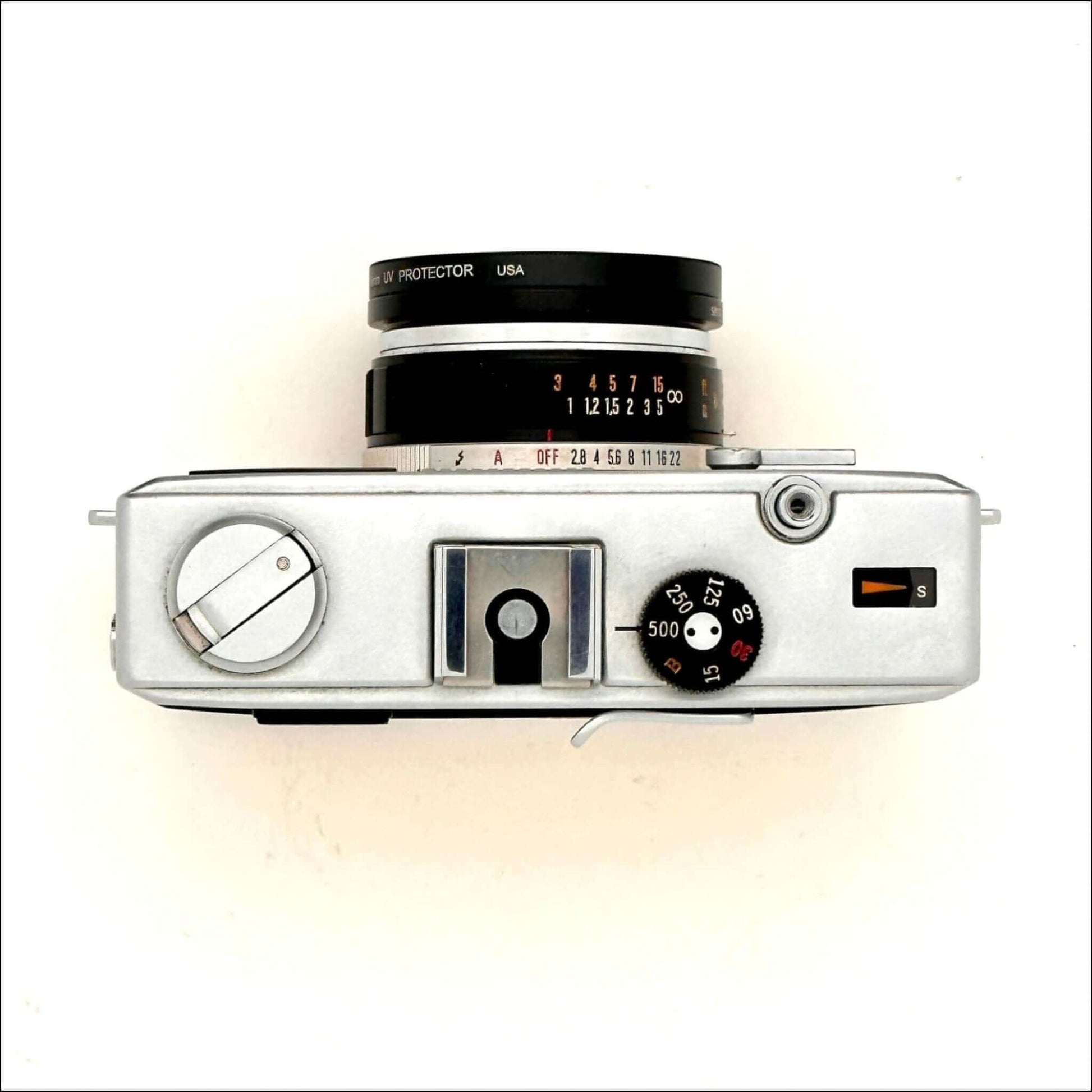 Olympus 35Rc 35mm yellow rangefinder film camera top view with dials and lens.