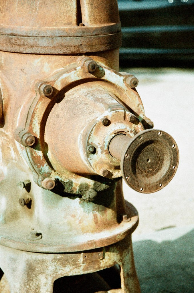 Close-up of the rusted, bolted outlet flange on an old water pump head, McAllen Pumphouse and Firemen’s Park, McAllen, Texas — Flic Film Tasty 200 35mm, Canon EOS A2E