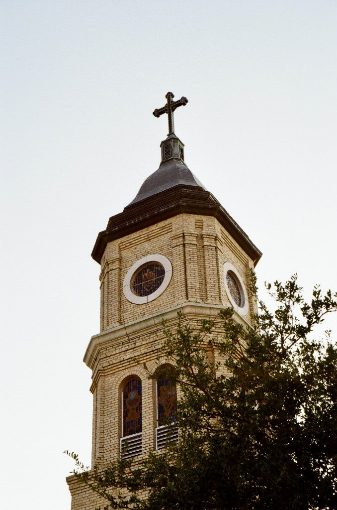 Brick church steeple with stained-glass windows looking up, shot on King Films Perutz 400 Color 35mm film, developed in Kodak C-41