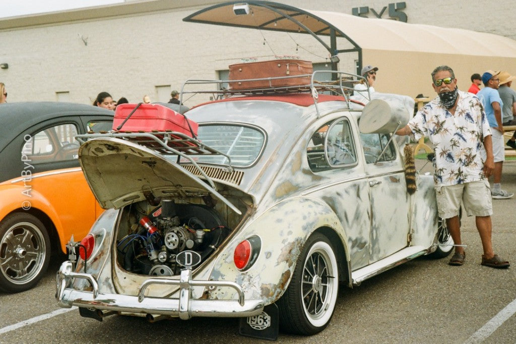 Patina white Volkswagen Beetle with engine compartment open at a 5x5 Brewing car show, shot on Leica M3 + Kodak Gold 35mm film, developed in C-41