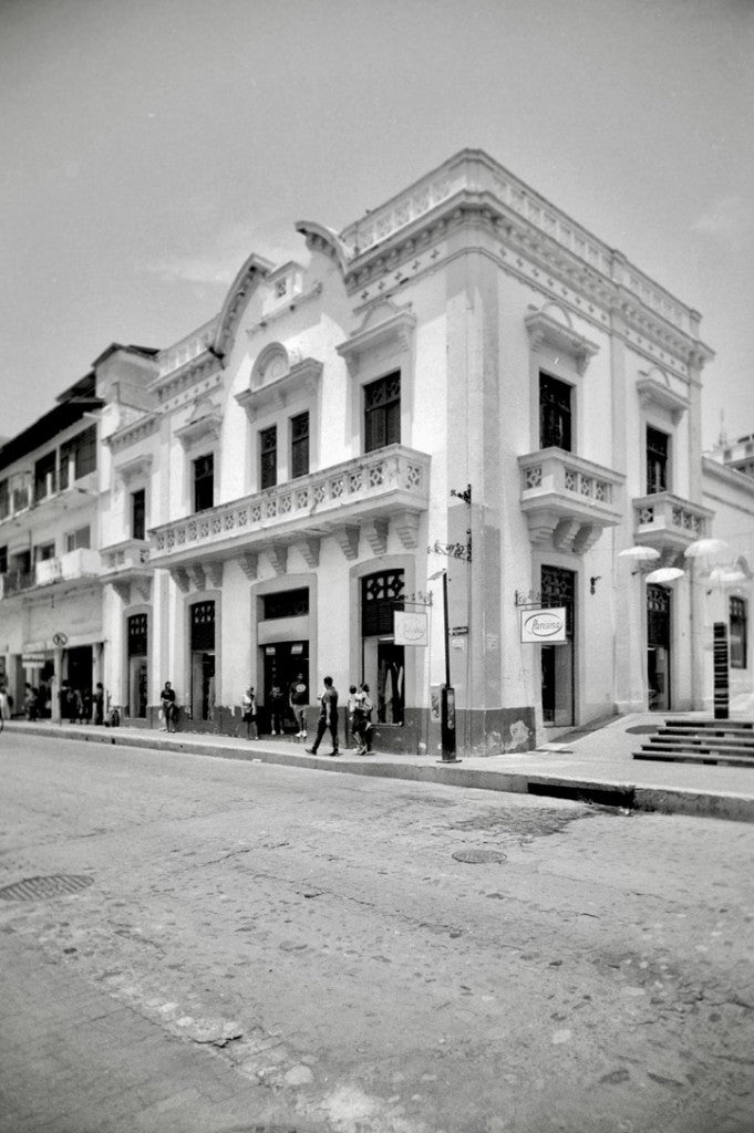 Two-story white colonial corner building with ornate balconies and shop signs, Puerto Vallarta — Kodak T-MAX 400 35mm, RETO Ultra Wide & Slim