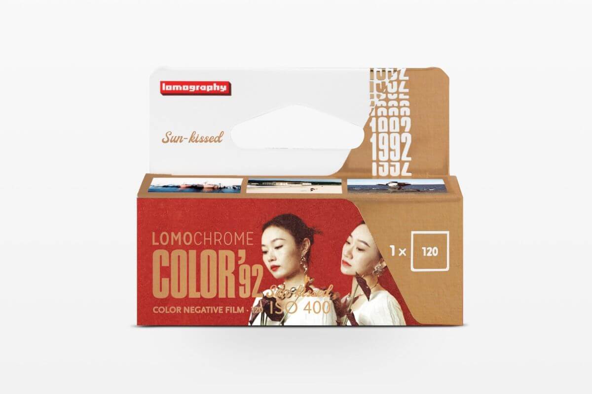 Red and brown cardboard box of lomography color 92 color negative film with a vintage aesthetic design featuring two women’s portraits.