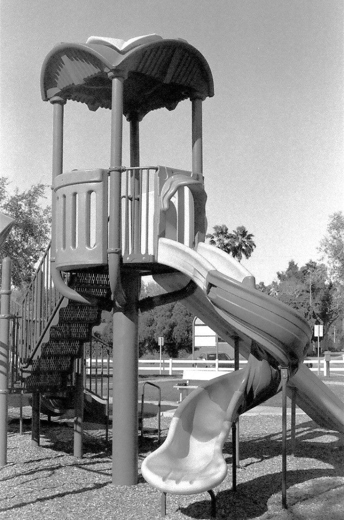 Pentax K1000 / 35mm + ORWO Wolfen P400 + Playground spiral slide tower on wood chips