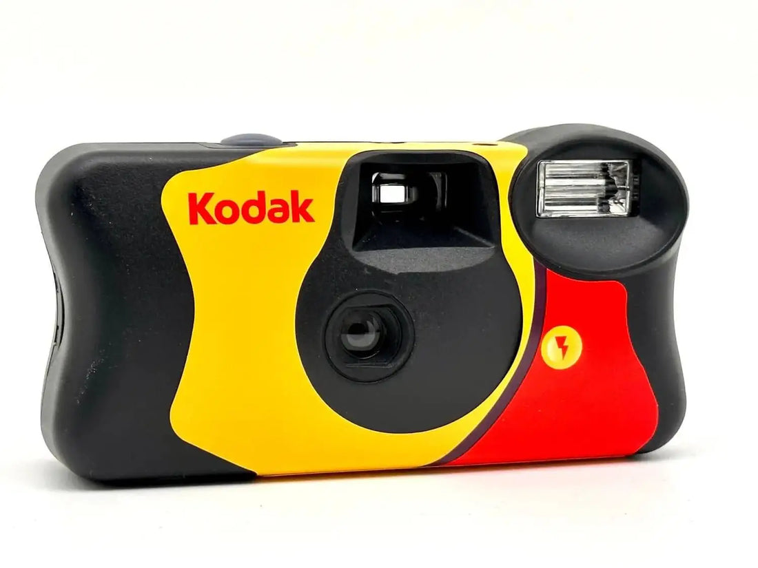 Vibrant yellow, red, and black kodak disposable camera with a built-in flash.