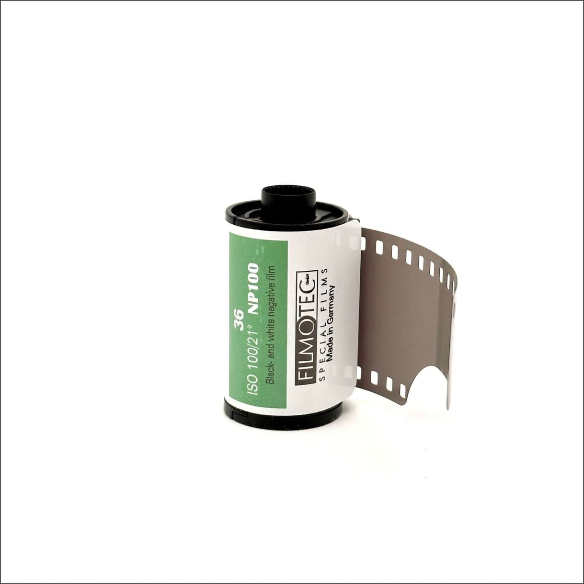 A roll of filmotec 35mm black-and-white negative film, featuring a white label with green and black text, housed in a standard cylindrical spool.