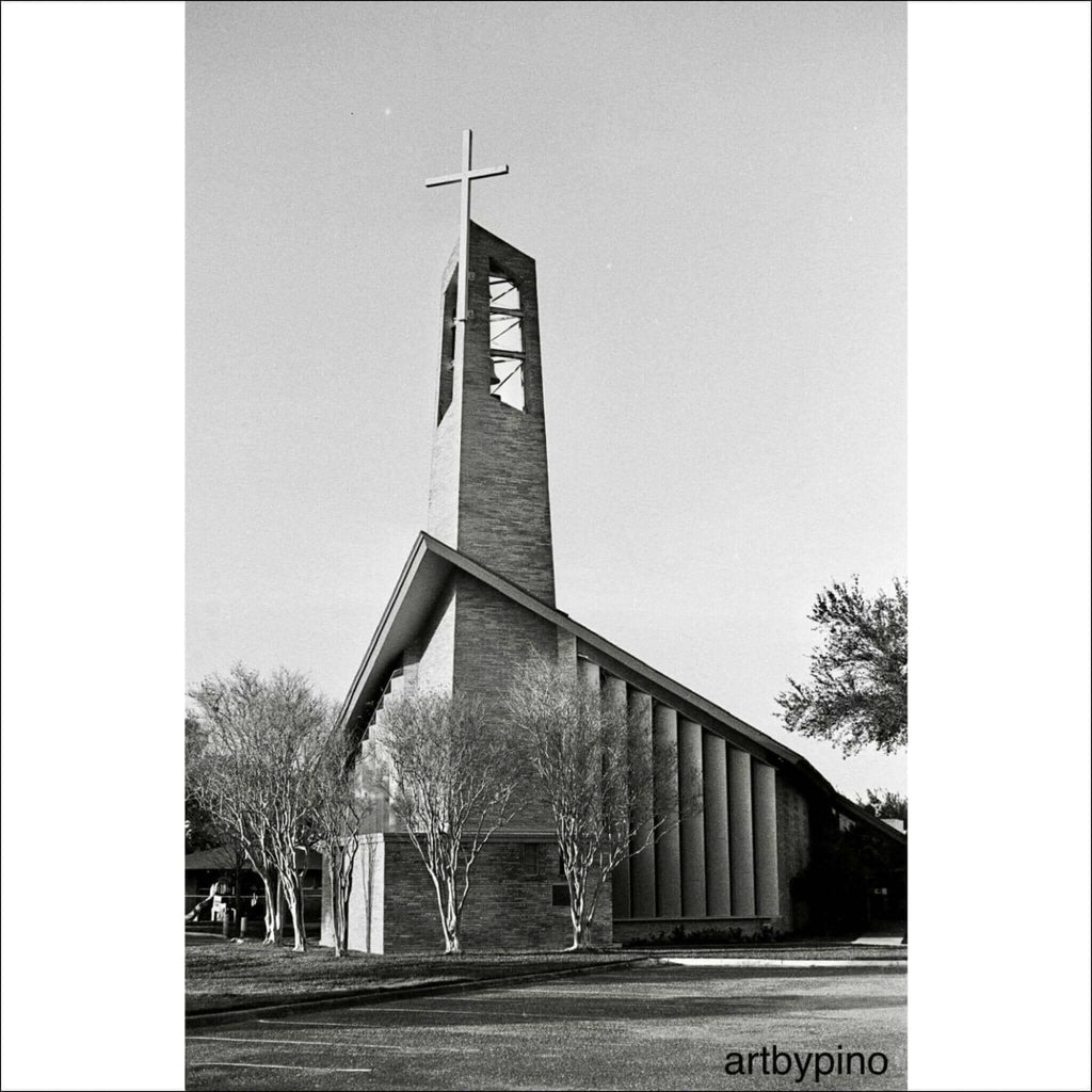Modern brick church with a tall, angular bell tower topped by a cross.