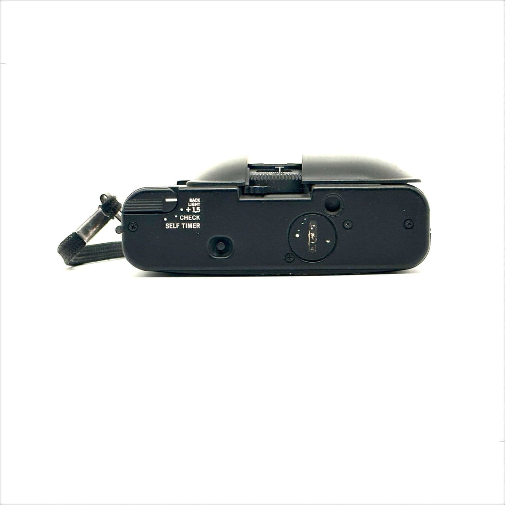 Black compact digital camera with a textured grip and visible control buttons.