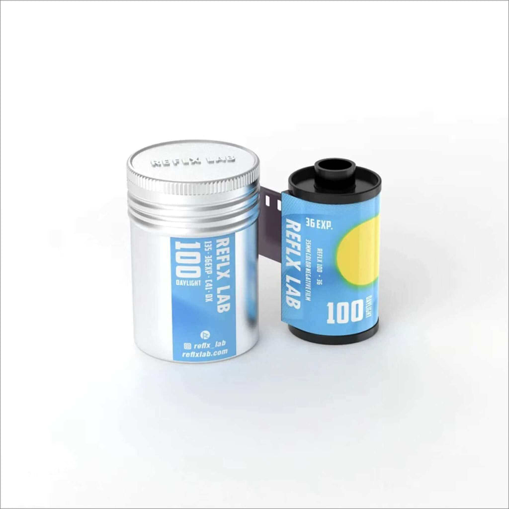 Silver cylindrical container with blue label and black film canister featuring a yellow circular design, both branded as ’reflex lab’