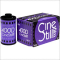 Purple cinestill 400d color film roll and box, featuring bold white lettering on a vibrant purple background with black accents.