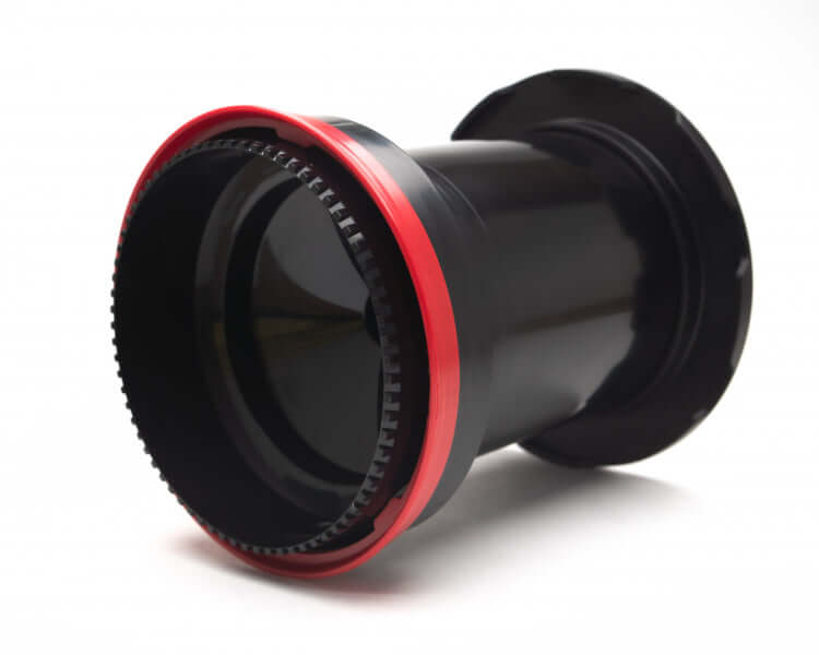 Close-up of a black and red camera lens on a white background