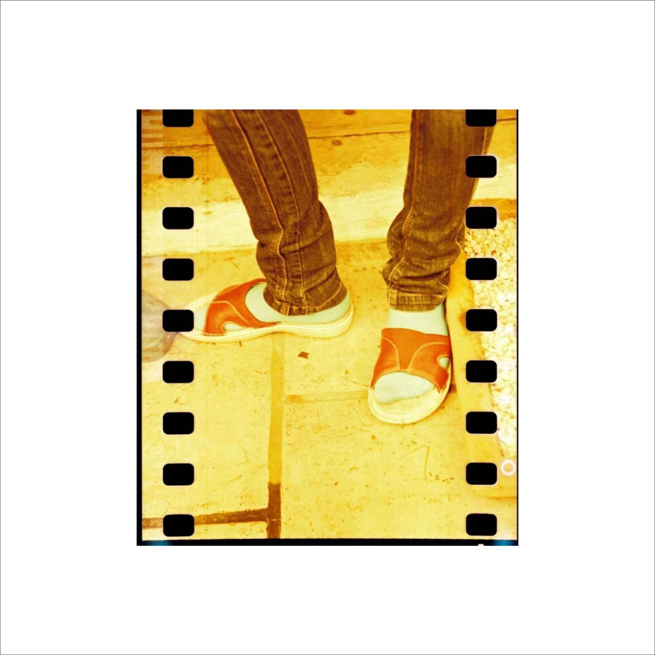 Orange and white slide sandals with a simple, open-toe design.