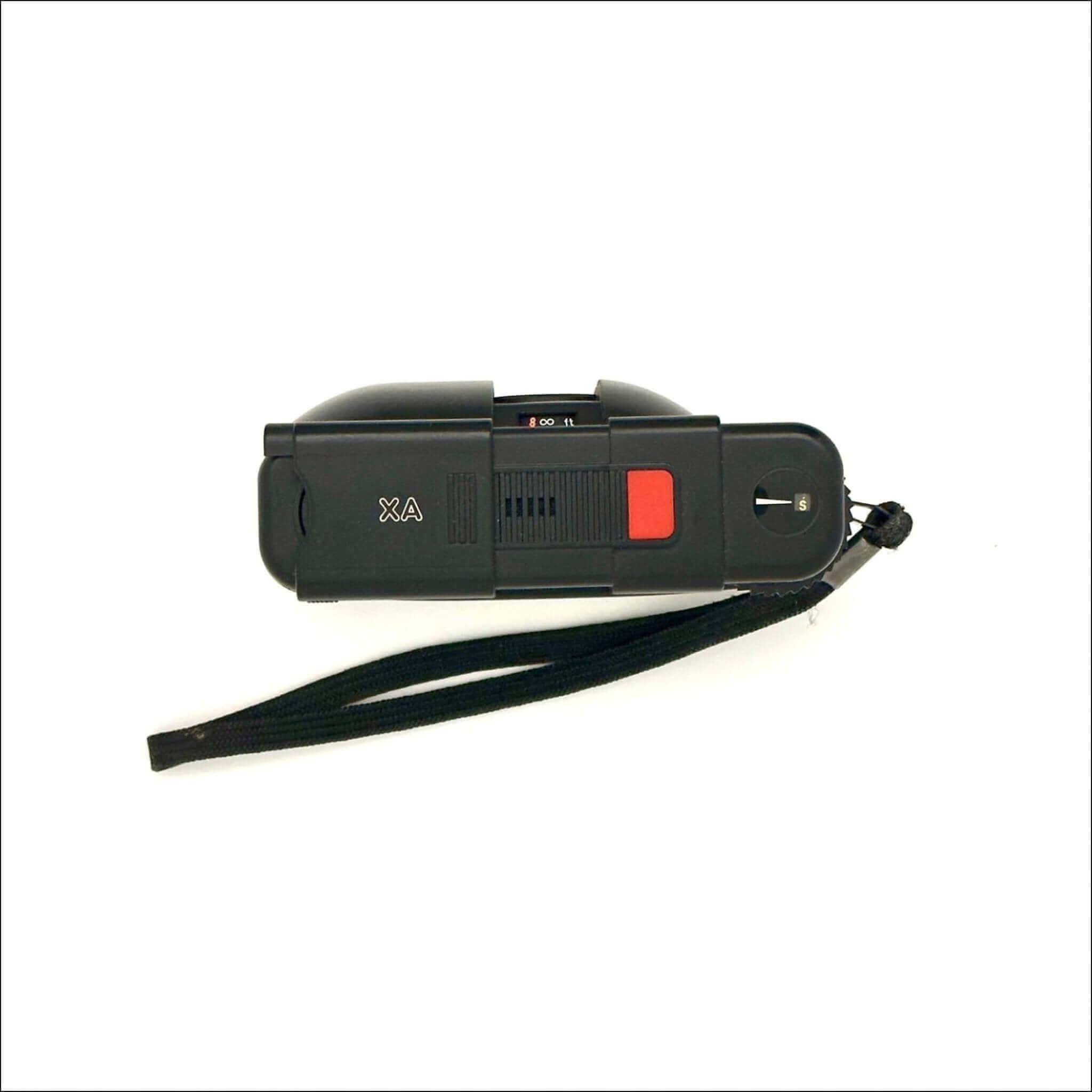 Black plastic stun gun with a red trigger and a black wrist strap.