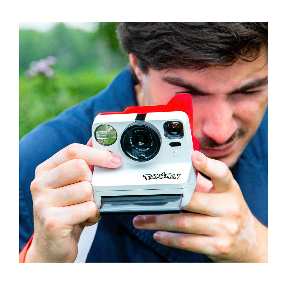 Photographer shooting with the Polaroid Now Gen 3 Pokémon Edition instant camera outdoors