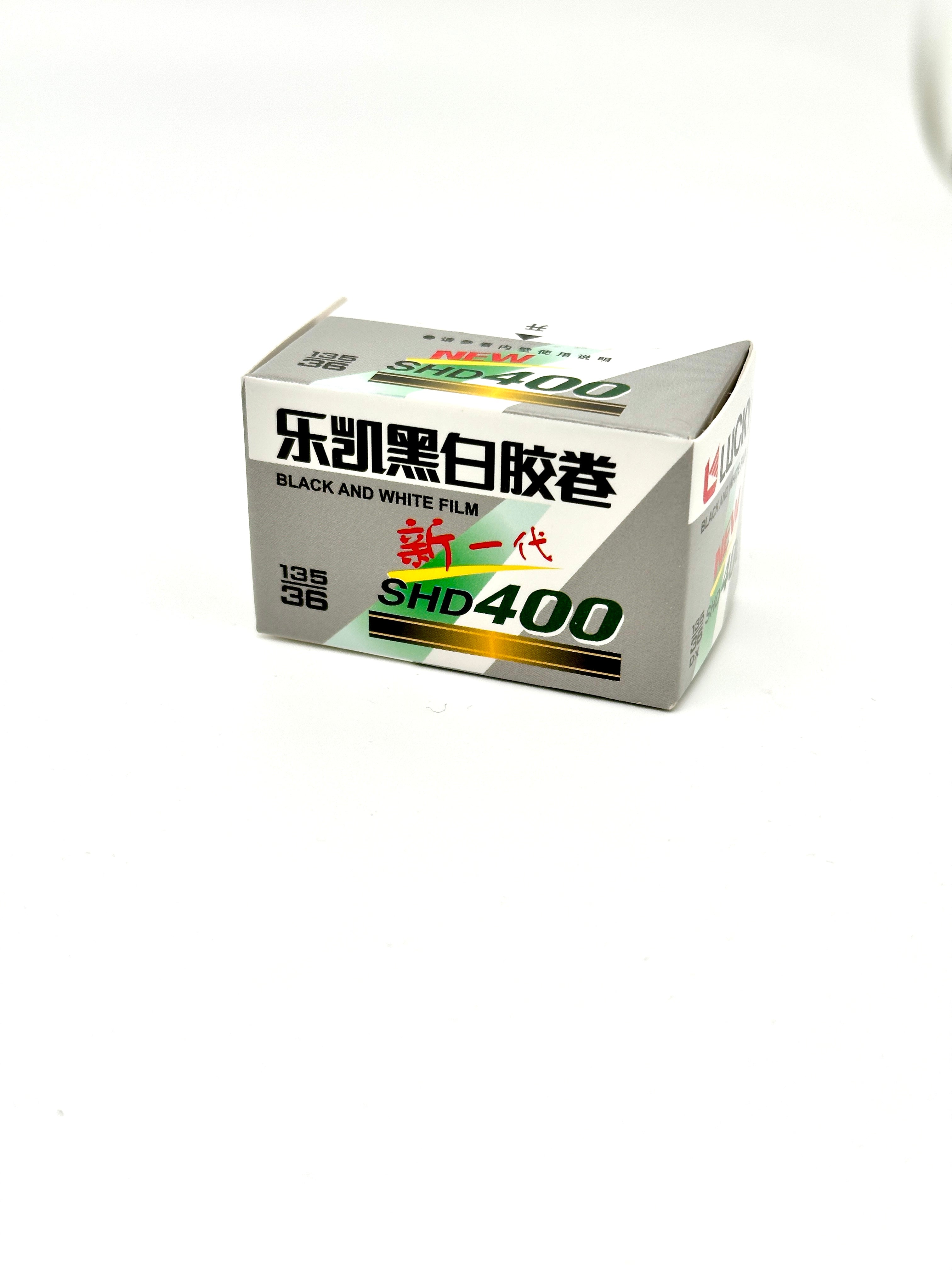 Silver and green labeled box of kodak shd400 black-and-white film.