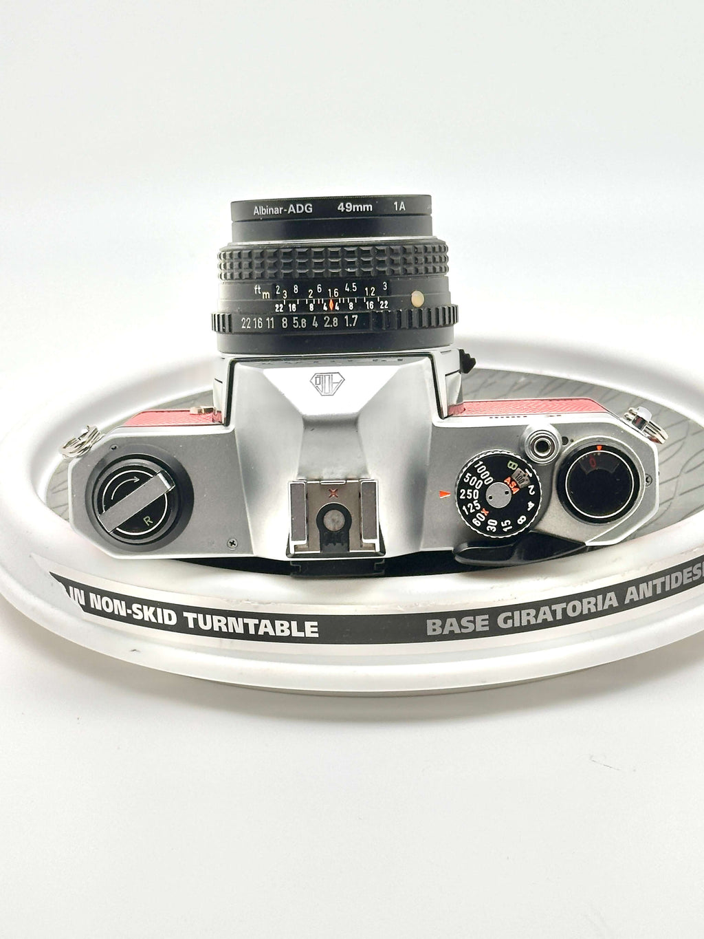 Vintage Japanese Asahi Pentax K1000 camera top view with 50mm f1.7 lens on non-skid turntable