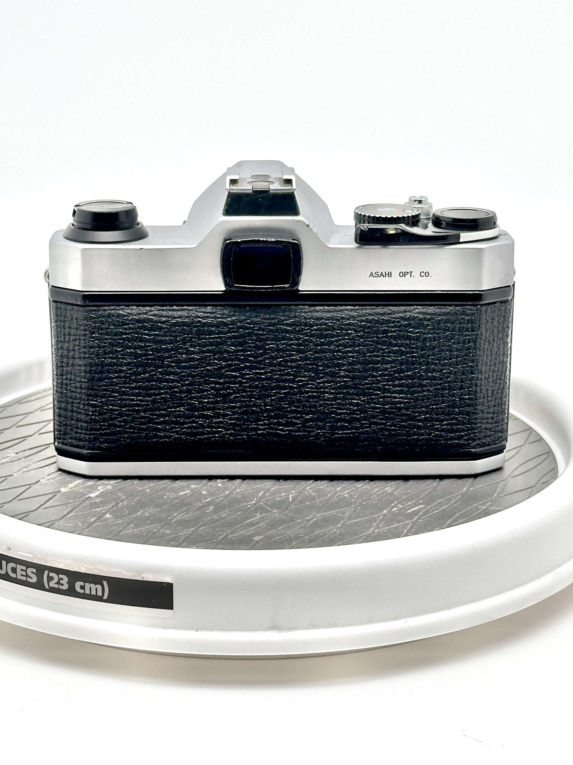 Back view of a Japanese Asahi Pentax K1000 black 35mm film camera, showcasing its classic design and smooth texture.