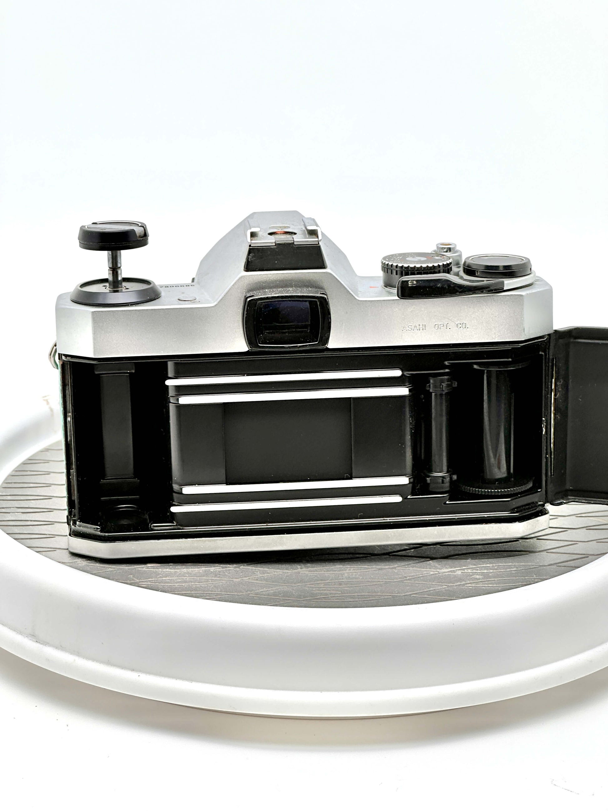 Rear view of a Japanese Asahi Pentax K1000 used 35mm film camera showing the film compartment and mechanisms.