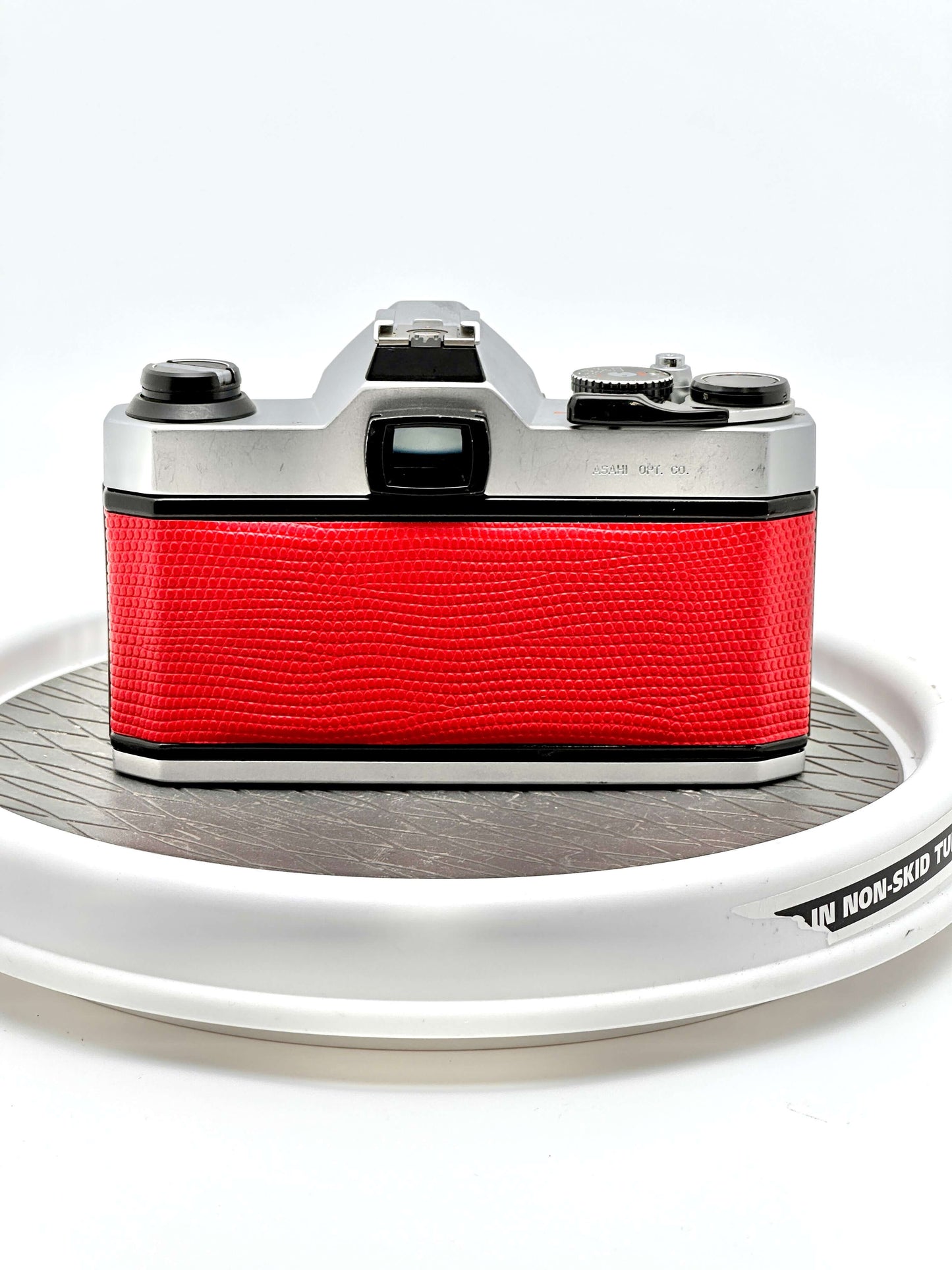 Vintage Japanese Asahi Pentax K1000 red 35mm film camera, showing the back design and textured grip.