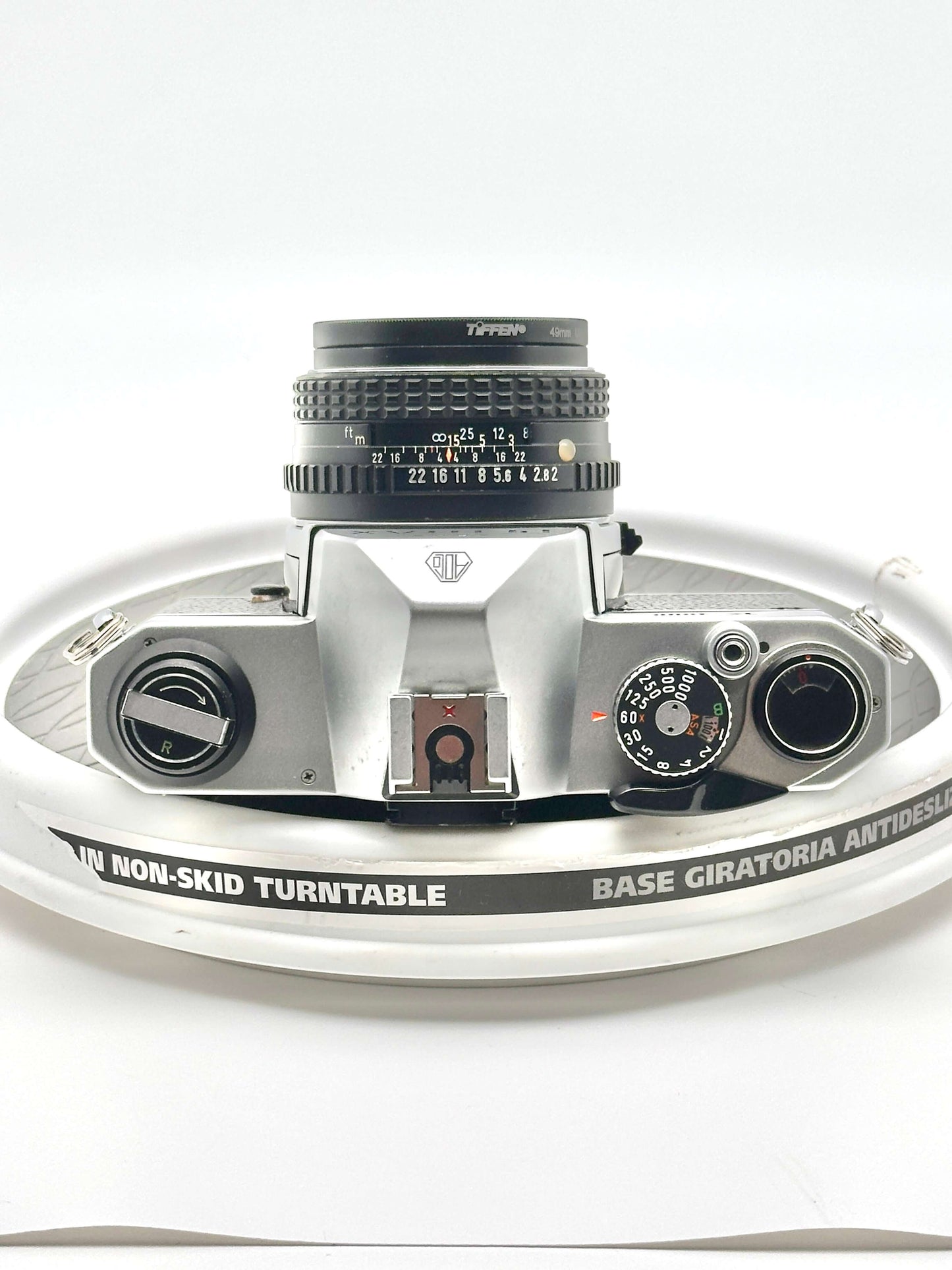 top view of a Japanese Pentax K1000 35mm film camera with 50mm f2 lens on a non-skid turntable