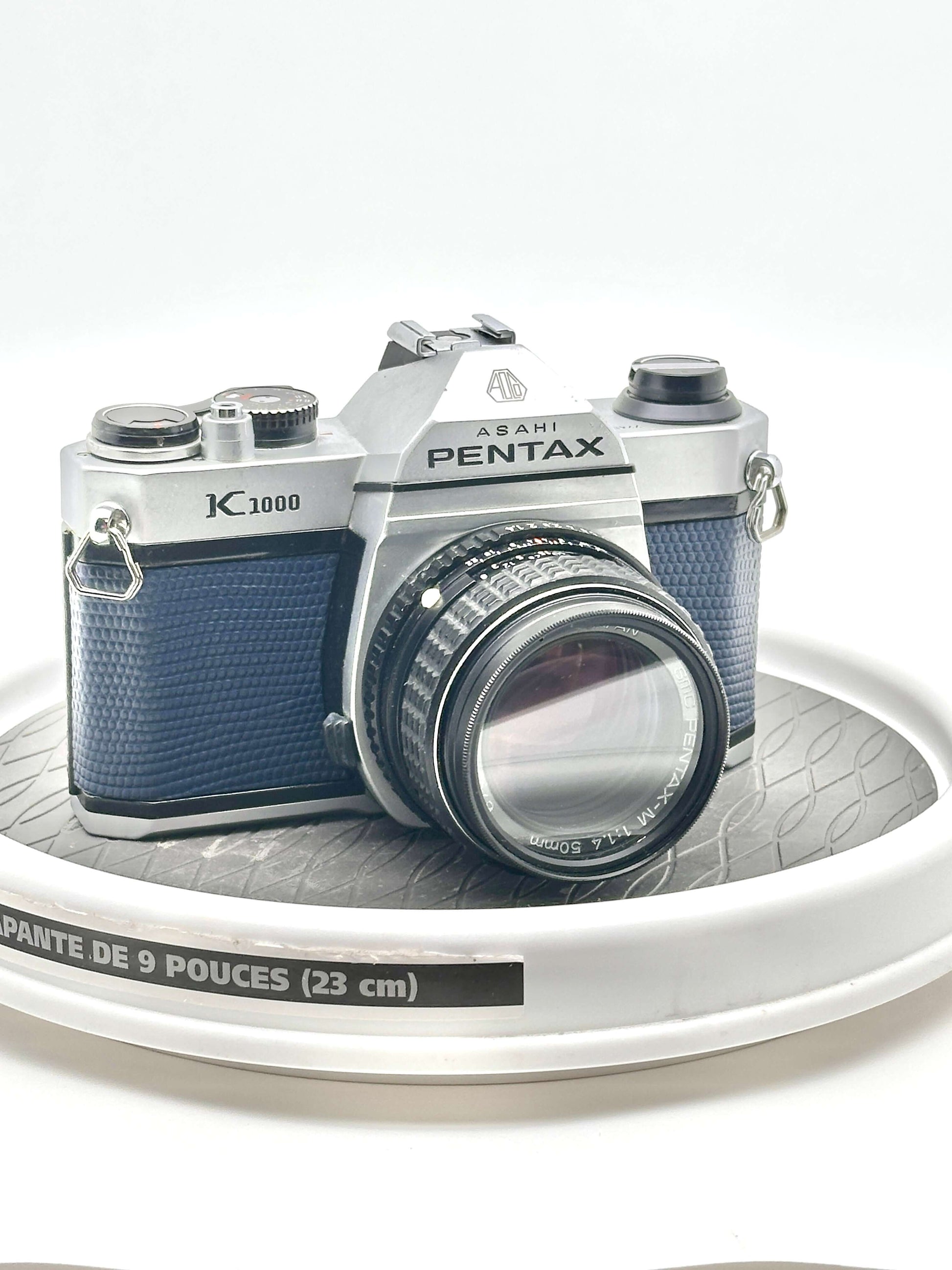 Used Asahi Pentax K1000 35mm film camera with 50mm f1.4 lens, featuring a blue design and iconic build.