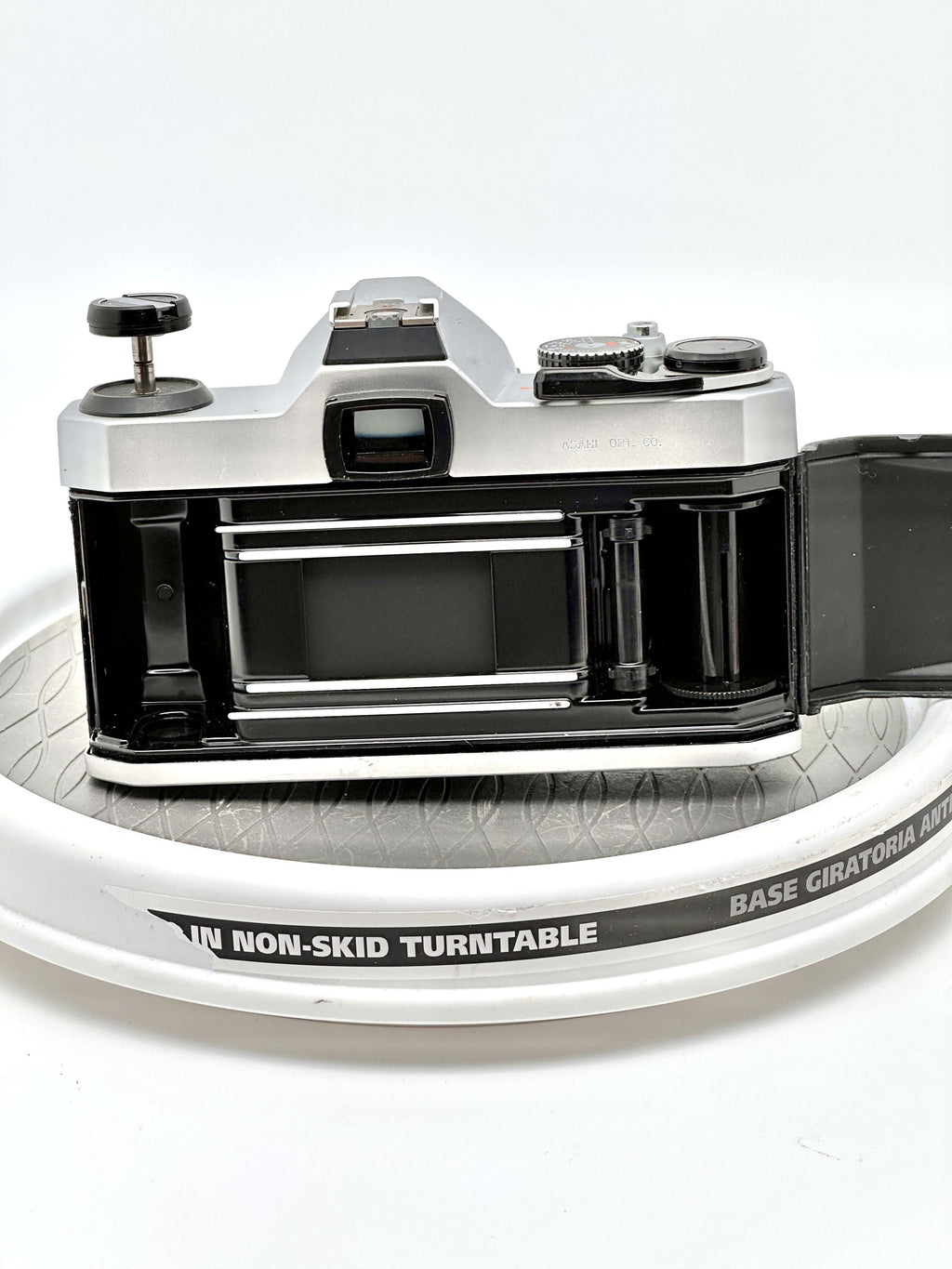 Silver and black vintage film camera with a classic rangefinder design, featuring metallic dials and a prominent viewfinder.