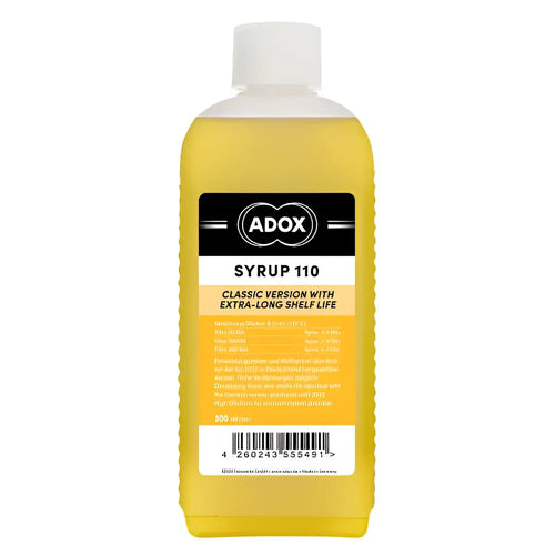 A yellow adox syrup 110 bottle with a white cap and an orange label featuring black text.