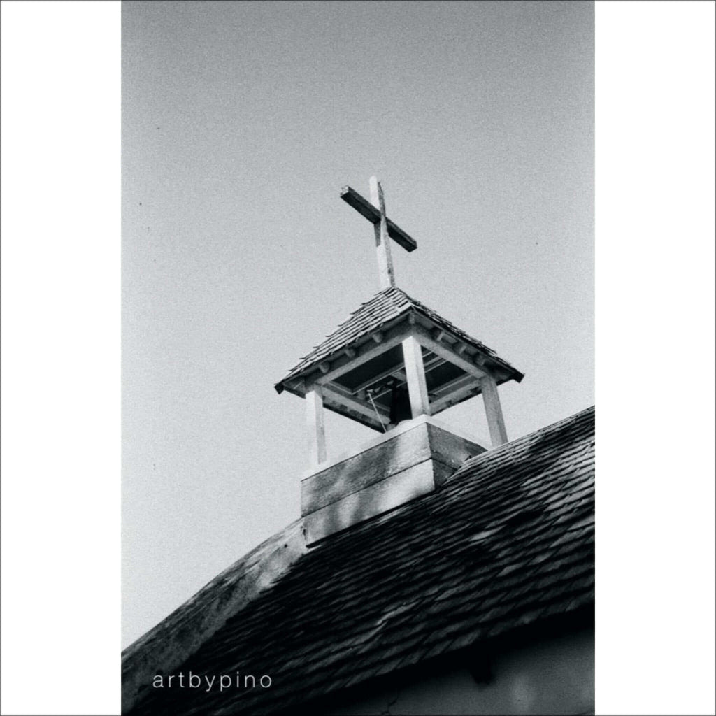 Wooden bell tower with a cross on top
