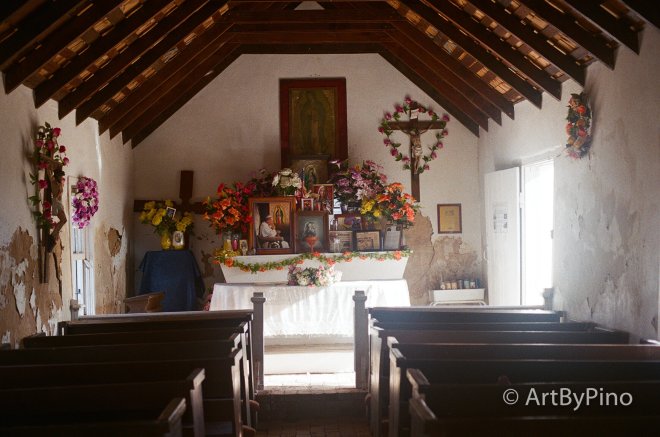 Altar with white cloth, vibrant flowers and icons under wooden beams, Texas view fullsize