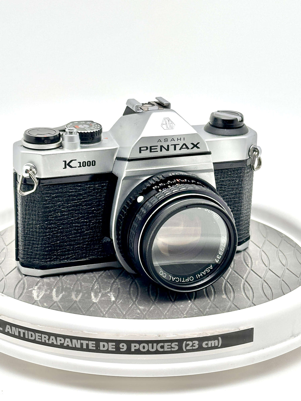 Asahi Pentax K1000 black used 35mm film camera with 50mm f2 lens on display.