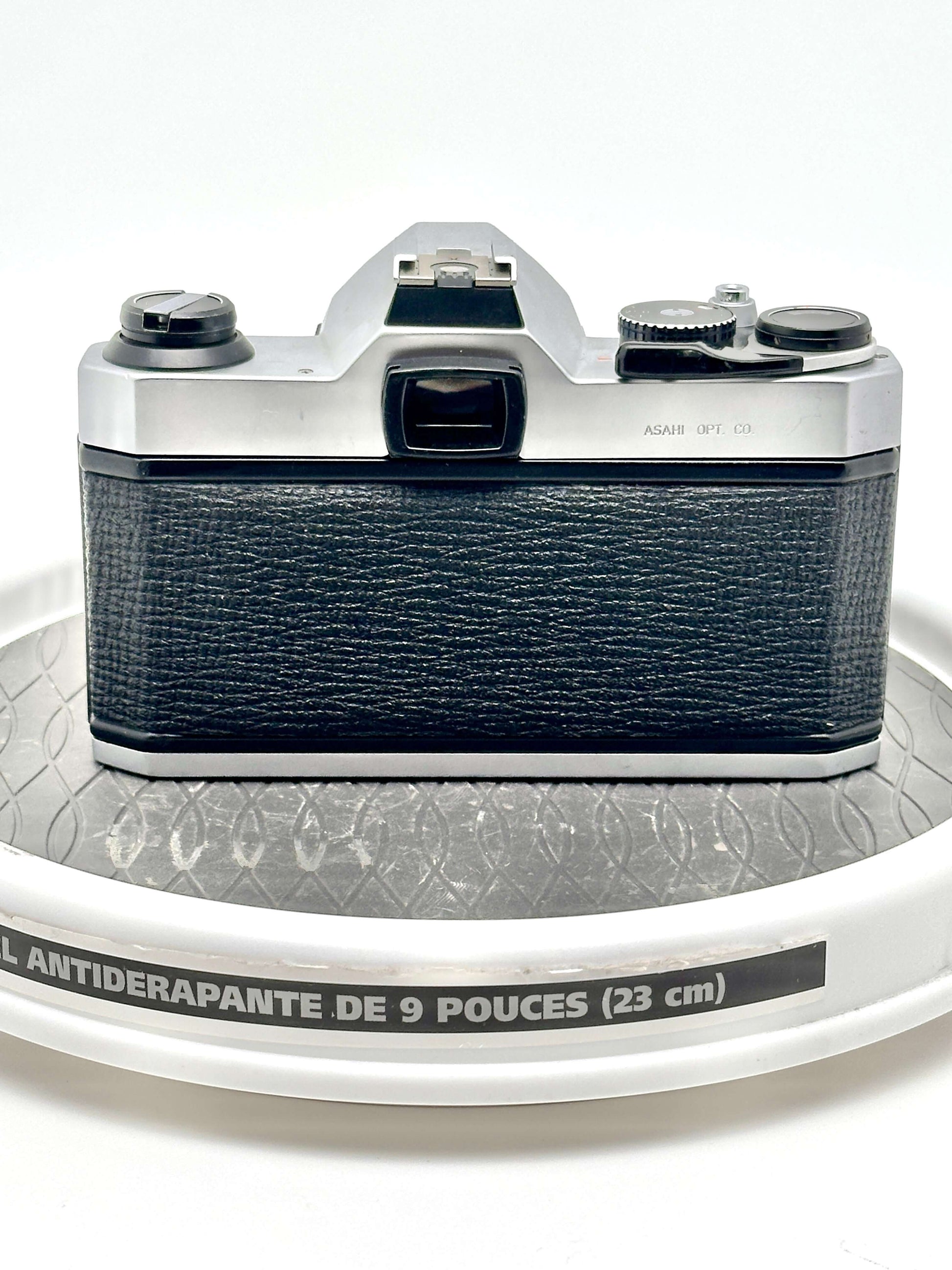 Back view of used Japanese Asahi Pentax K1000 black 35mm film camera showing textured grip and controls.