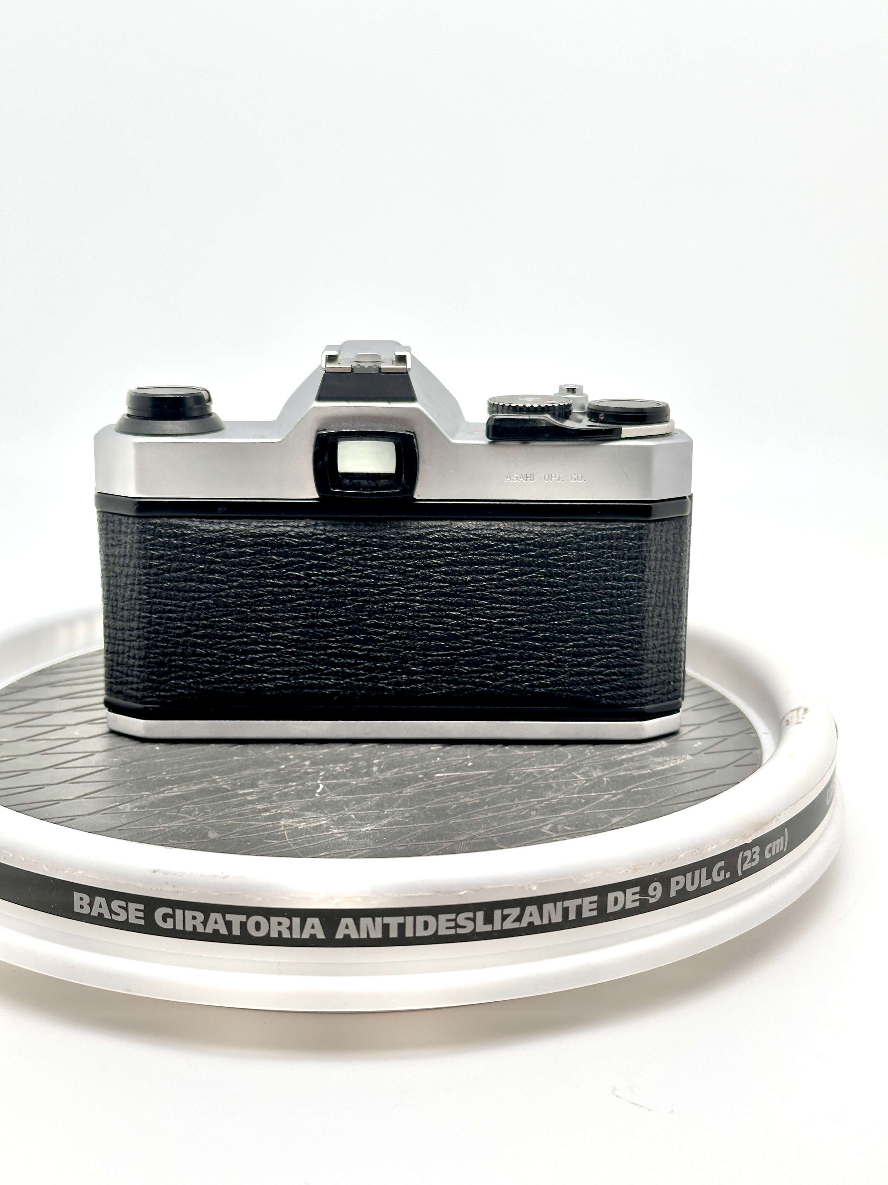 Silver and black canon ae-1 film camera with textured leather grip.