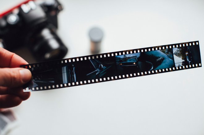 Black film negative strip with grainy sequential frames for slide scanning services