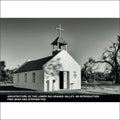 A small, white adobe church with a bell tower topped by a cross.