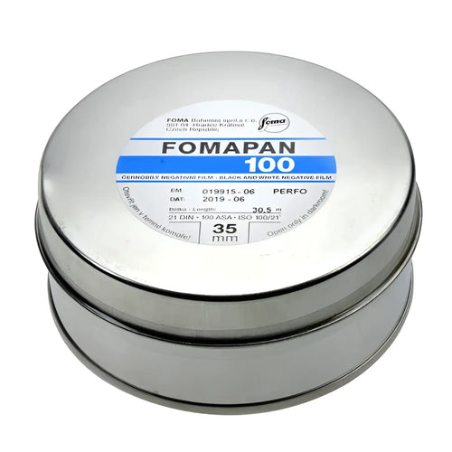Silver cylindrical canister of fomapan 100 black and white negative film.