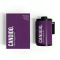 Purple candido 35mm color negative film canister with black caps and white branding beside matching purple box