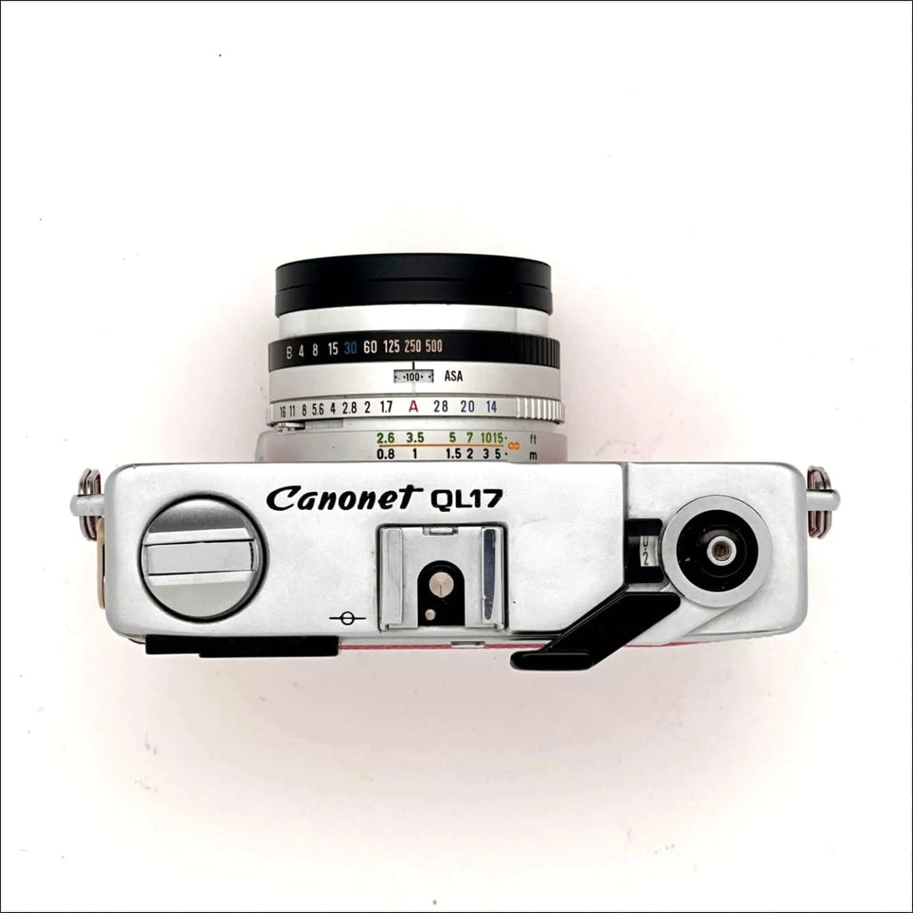 Silver canonet ql17 film camera with a black lens and white engraved markings.