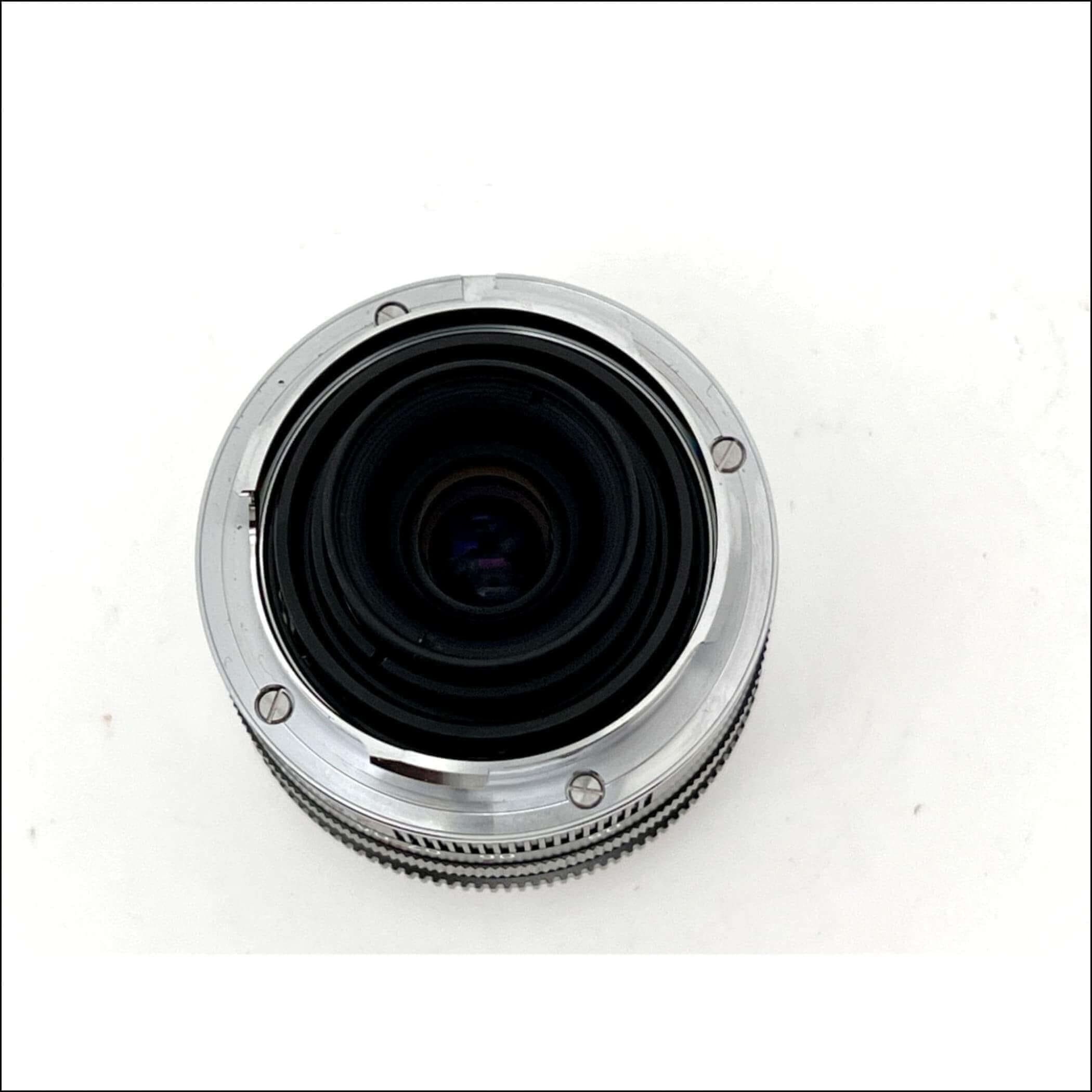 Silver chrome camera lens with a textured focus ring and black glass elements.