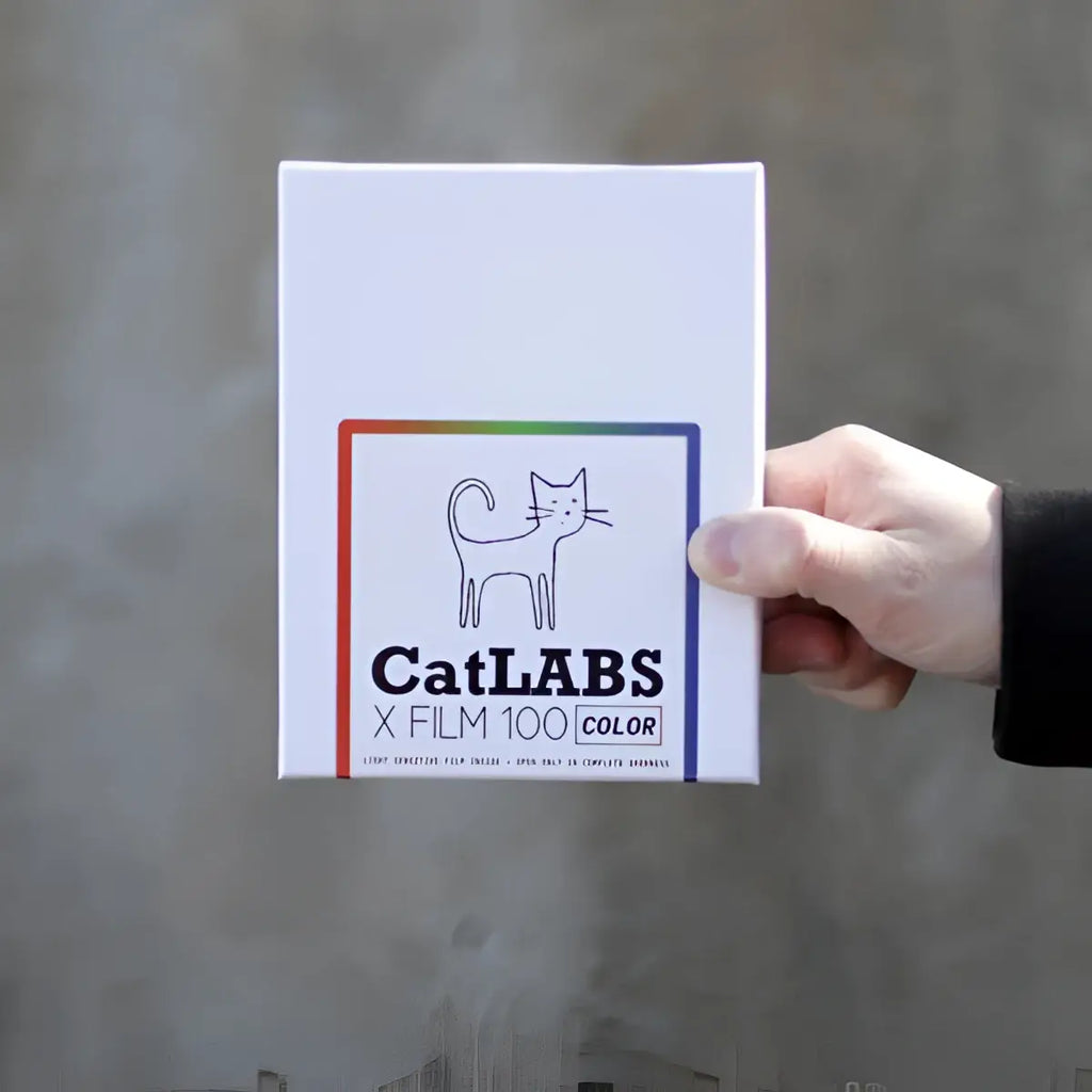 White rectangular box of catlabs x film 100 color negative film with minimalist black cat line drawing in rainbow border