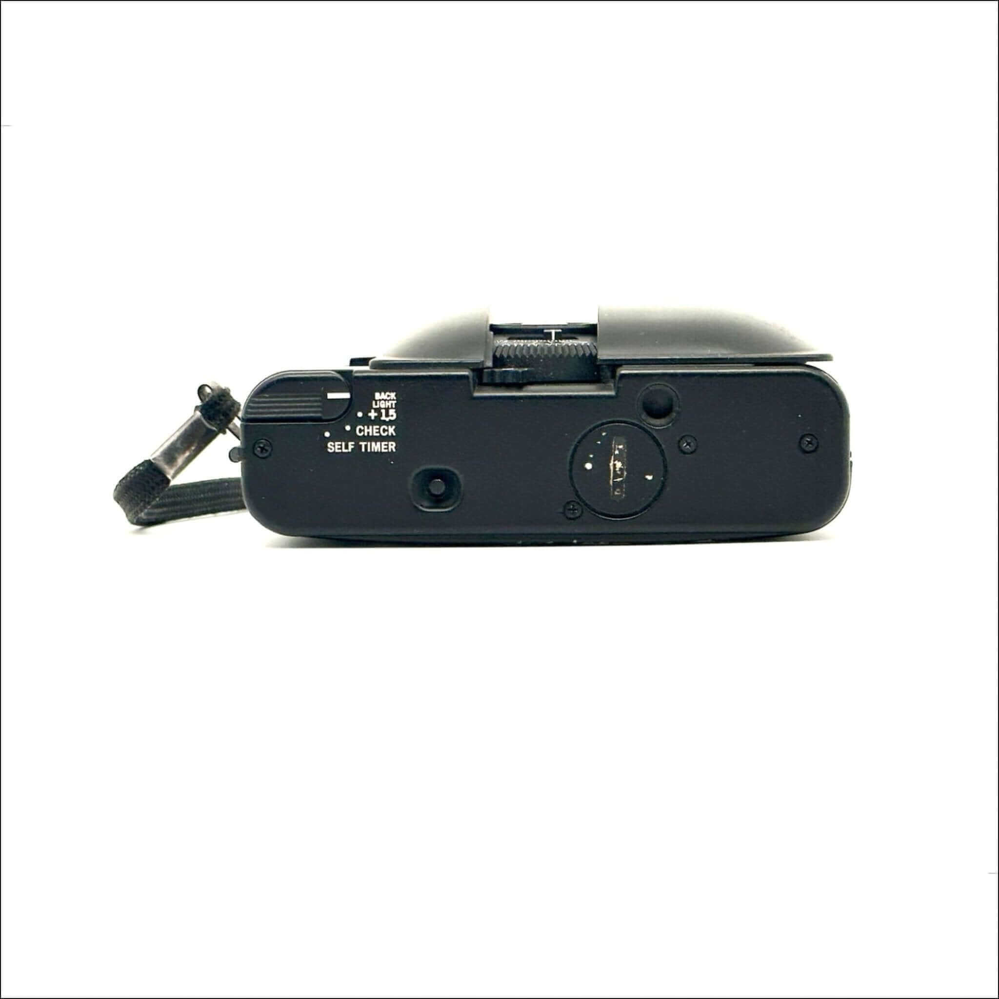 Black fujifilm compact camera with a textured grip and visible control dials.