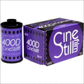 Purple cinestill 400d color film roll and box, featuring bold white lettering on a vibrant purple background with black accents.