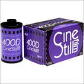 Purple cinestill 400d color film roll and box, featuring bold white lettering on a vibrant purple background with black accents.