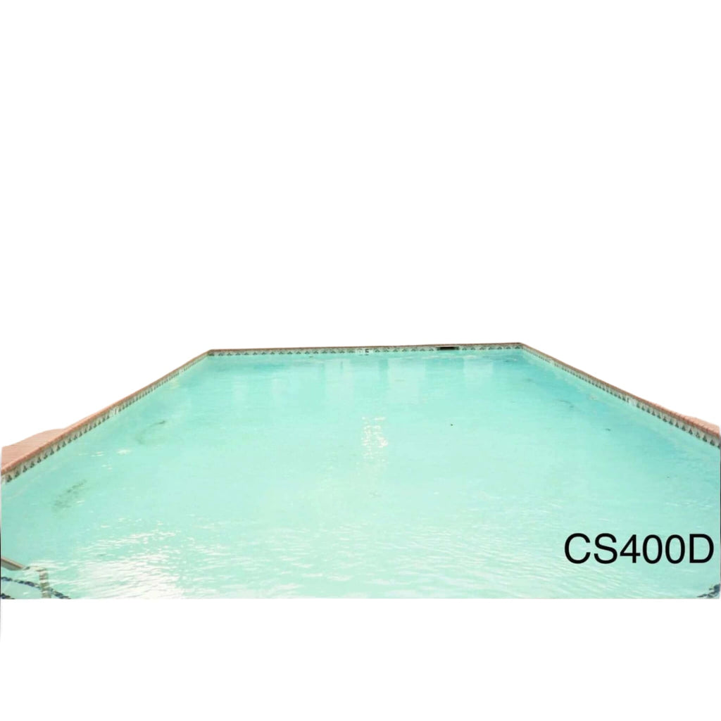 Rectangular in shape with clear turquoise water and tiled edges, surrounded by lounge chairs and a brick wall