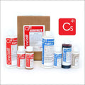Cinestill c41 quattro kit containing various bottles of color developer, bleach fixer, and rinse solutions in white, blue, and brown containers with red or blue labels.