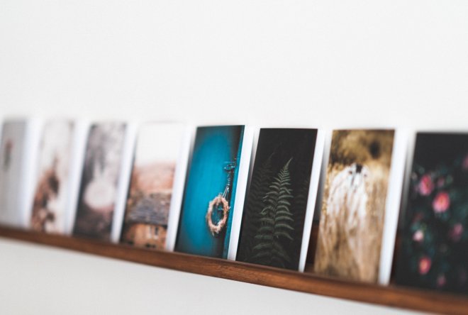 Professional photo prints on wooden shelf with nature and abstract designs