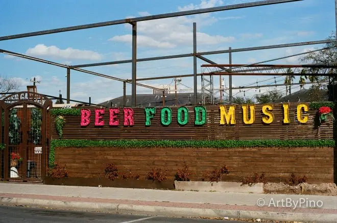 Colorful beer food music sign on rustic wall, Texas view fullsize