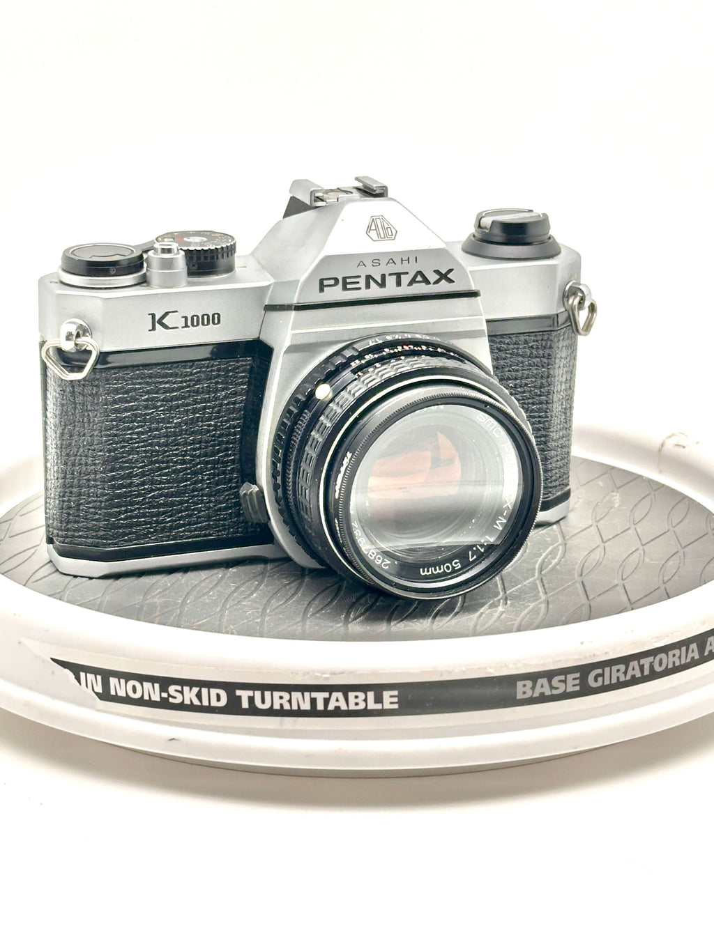 Silver and black asahi pentax k-1000 film camera with a textured leather grip.