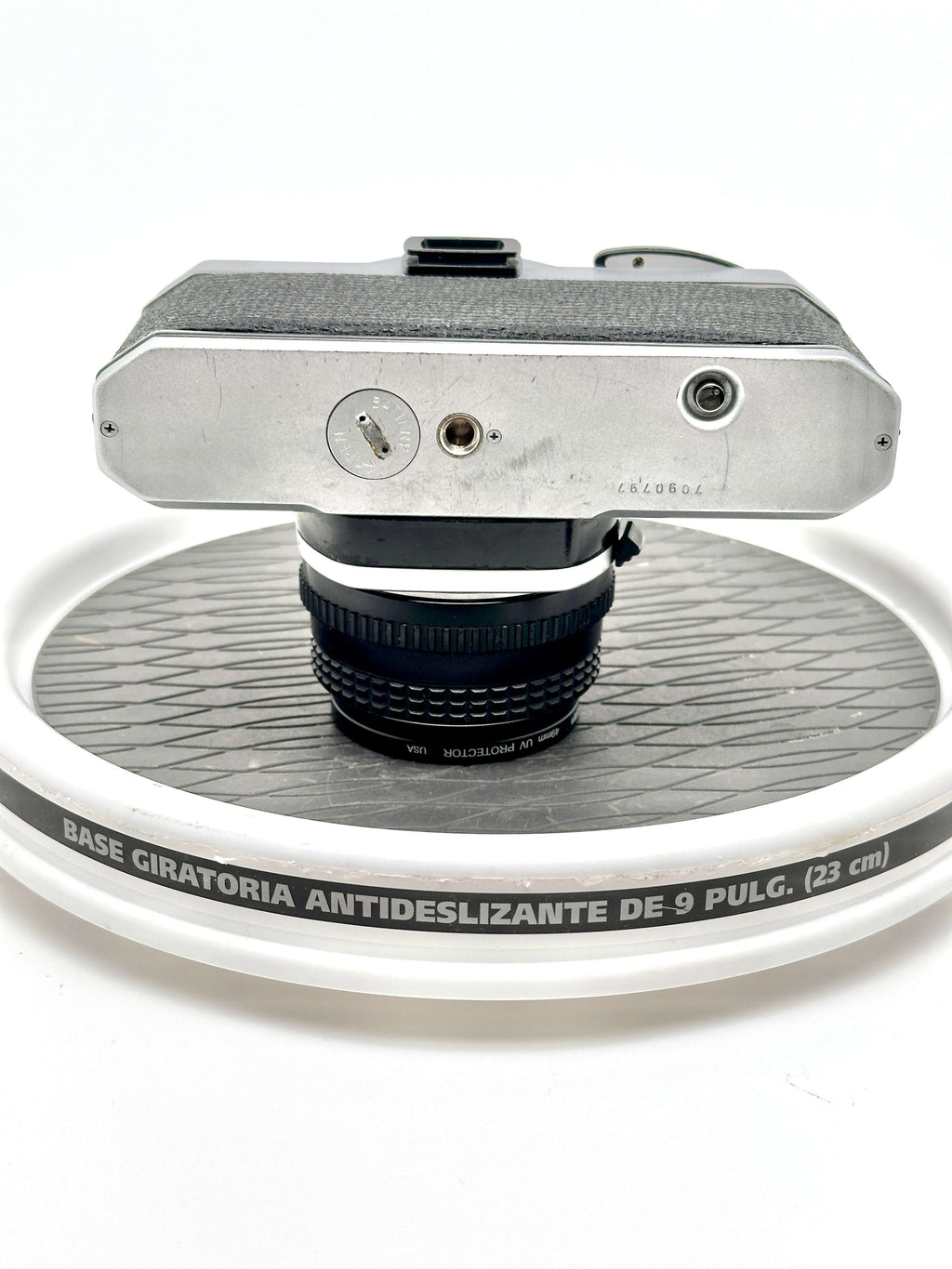 Silver-bodied vintage camera with textured black grip and a mounted lens.